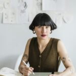Portrait of a focused artist drawing with a digital tablet in a modern studio.
